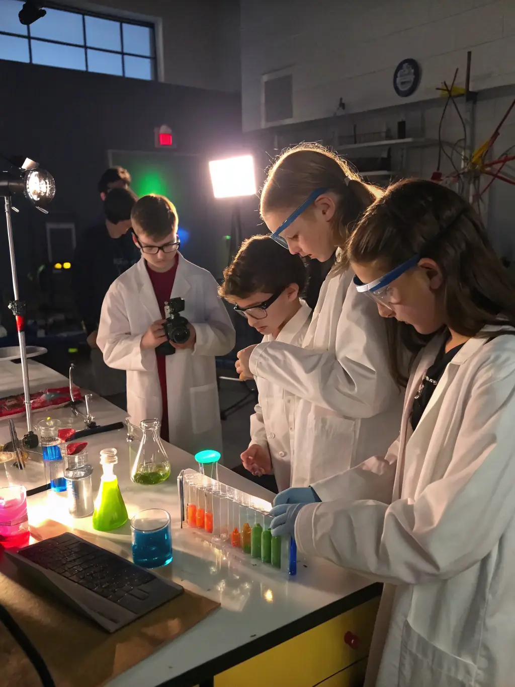 A well-equipped science lab with students conducting experiments under the guidance of a teacher, emphasizing hands-on learning.